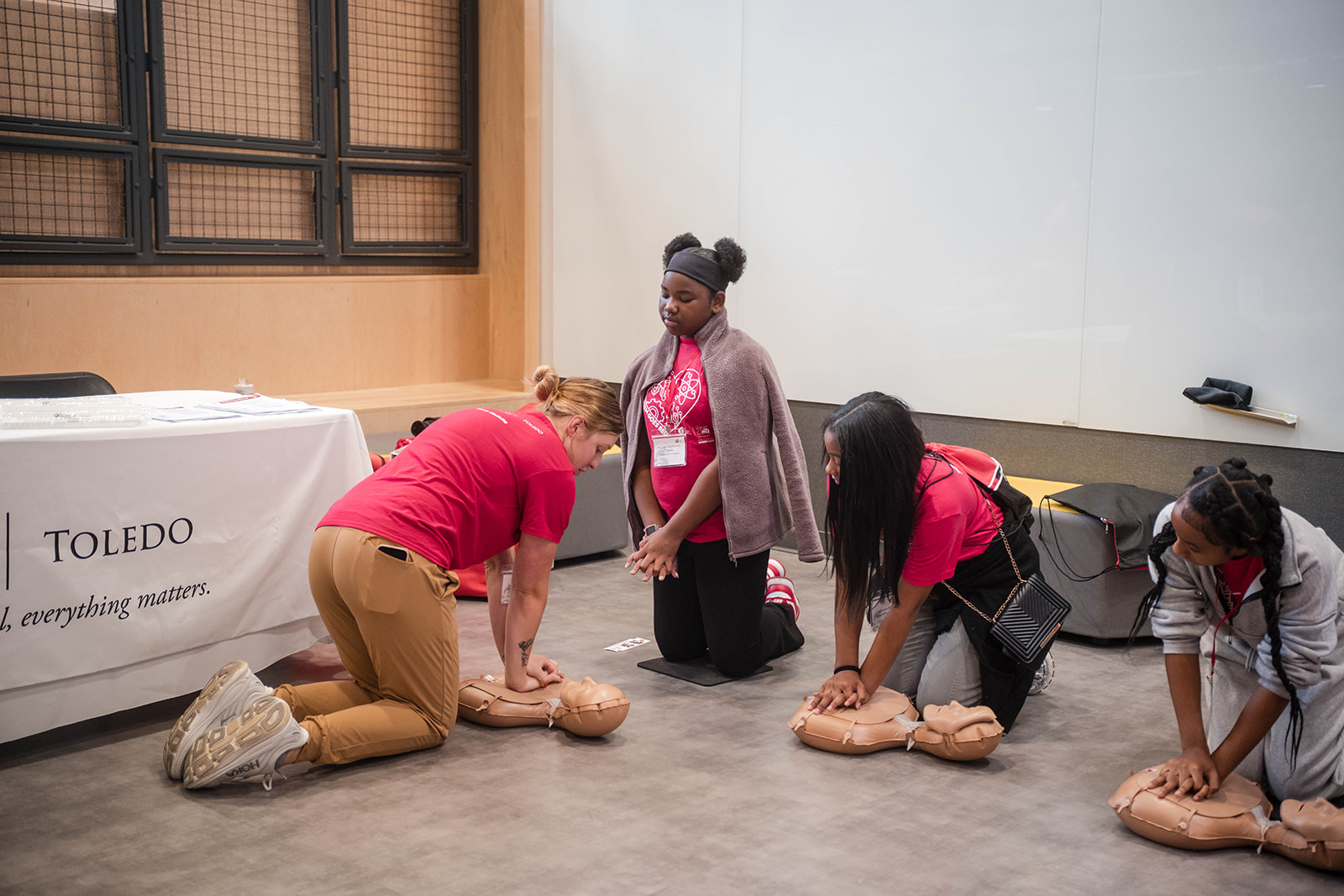 Group of girls learning hands-only CPR.